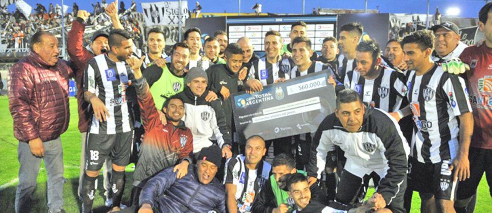 Los jugadores posan felices con el cheque simbólico con el que se premia al equipo que sigue en carrera