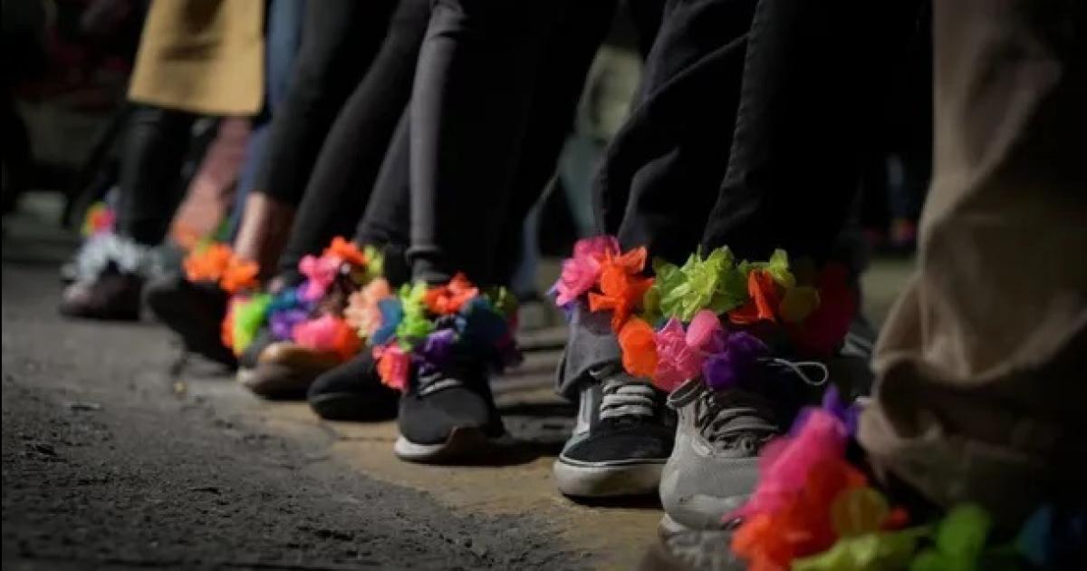 Mujeres llevan tobilleras de flores frente a la casa de Cristina Kirchner